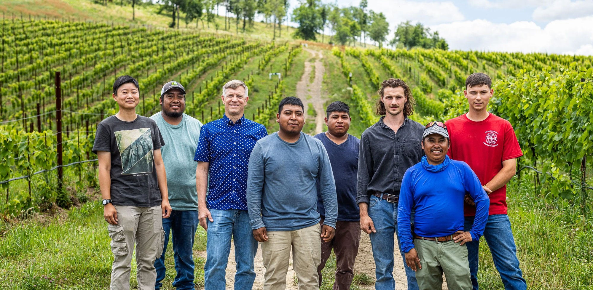 Part of our team at Klocke Estate, standing in one of our vineyards.
